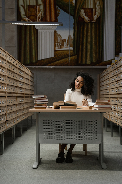 A student reading at a desk in the RTM-AKTU library
